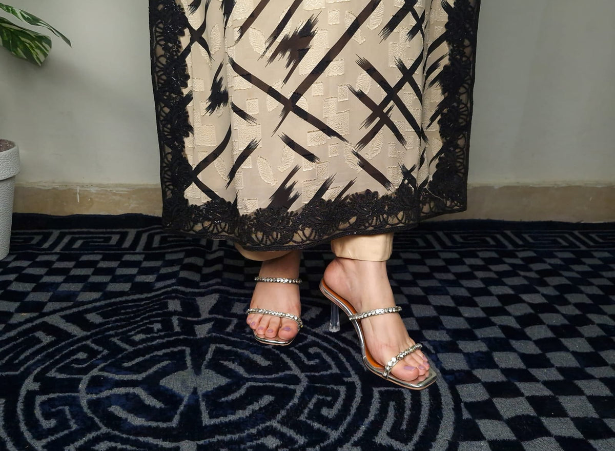 Girl wearing a patterned skirt and sandals on a checkered floor
